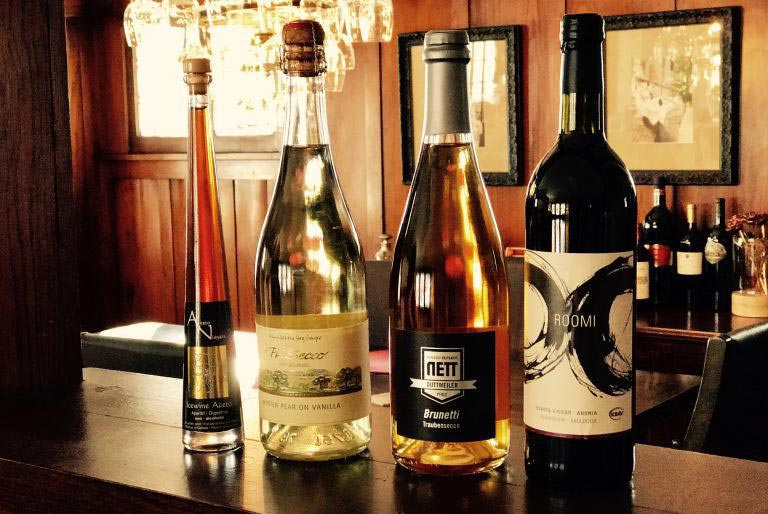 Various Delmosa non-alcoholic bottles standing on a table next to each other on display.