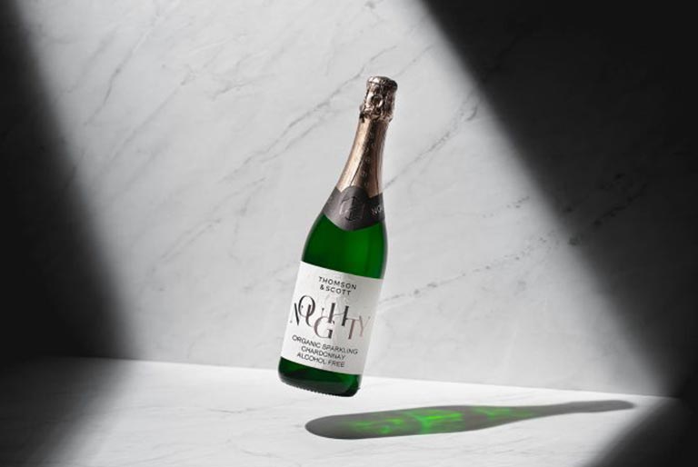 A non-alcoholic bottle floating in the air